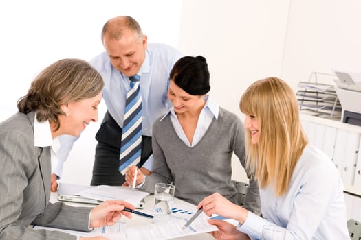 Business team meeting senior businesswoman with happy colleagues in office