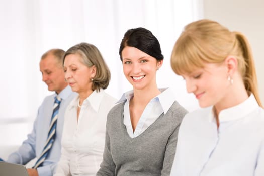Young businesswoman smiling meeting with team colleagues
