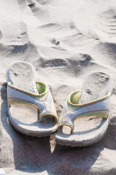 Shot of  flip flops on sand, sunny day