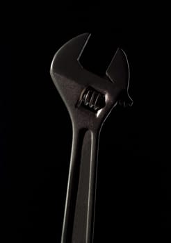 Single Monkeywrench on black background