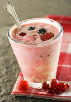 mixed berry yogurt in glass close up shoot
