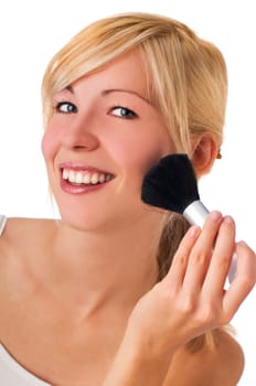 Portrait of attractive young adult woman applying blusher