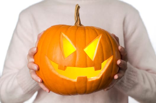 close up of a woman holding orange pumpkin