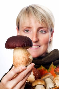 young blond woman holding mushrooms close up
