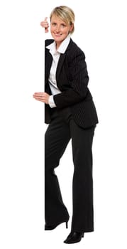 young business woman peaking isolated on white