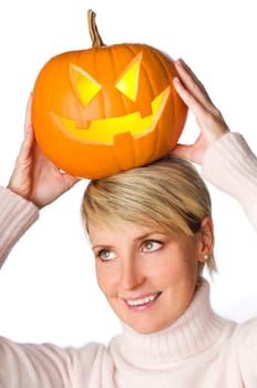young blond woman holding orange pumpkin close up