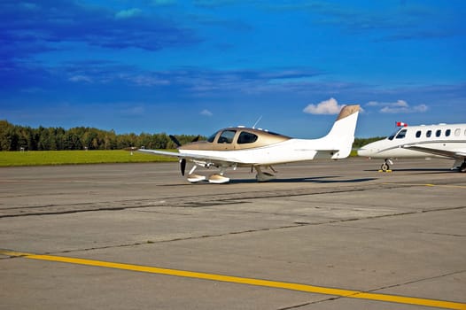 Two small passenger planes on the runway waiting for their passengers