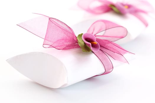 Small gift box decorated with ribbon and flower