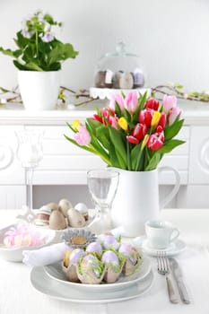 Place setting for Easter with eggs and tulips