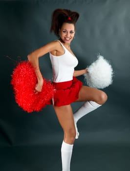 Young lady cheerleader posing in the studio.