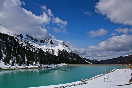 Lake in Austrian Alpes with mountains in the background