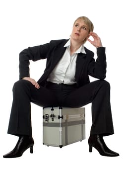 young business women sitting on silver case waiting on white