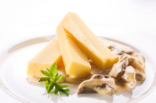 Healthy polenta with creamy mushroom sauce close up