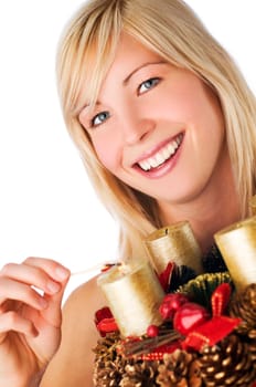 young blond girl holding advent wreath on white
