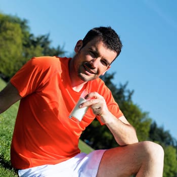 man is drinking fresh glass of milk in a park