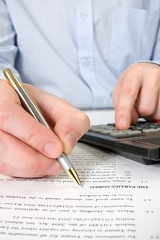 businessman&#039 s hand with pen,documents and calculator