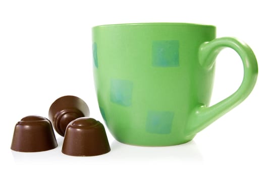 coffee cup with chocolate pralines. isolated on white background