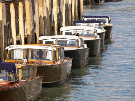 traditional Wooden boats on canal in venice