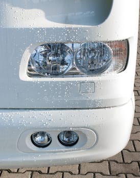 headlight unit and fog lights of a white truck