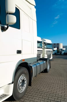 white trucks for rental on an industrial area