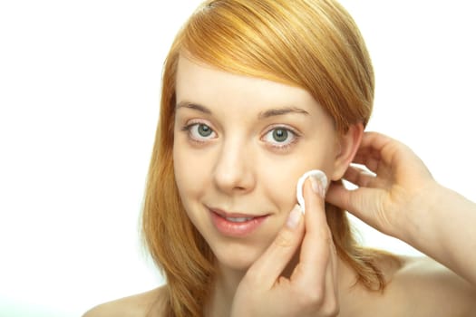 young redhead remove make up with pad