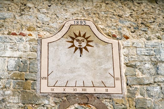 sundial old rustic wall of a Spanish village