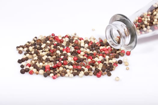 Mixed pepper with jar isolated on white background