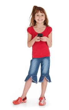 Full length view of little girl standing, holding iPhone, on white background.