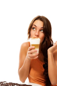 Young woman drinking latte macchiato coffee and looking up against white background