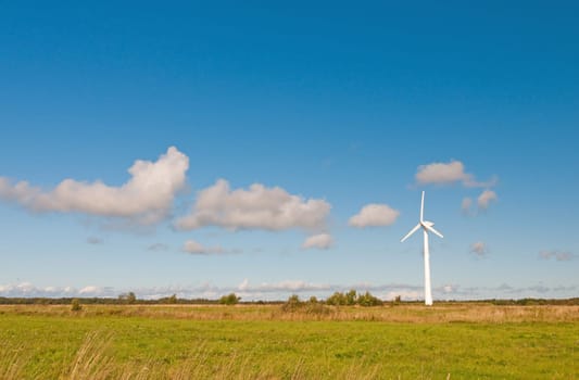 Shot of landscape with windmill and blue sky