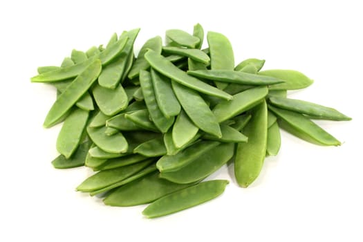 green sugar snap peas against white background