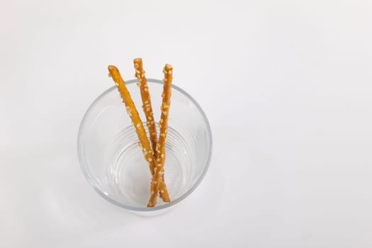 The last three remaining pretzel sticks in the jar