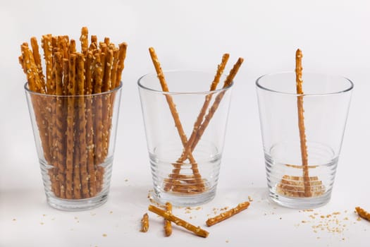 Three glasses of pretzel sticks much,little,only one more