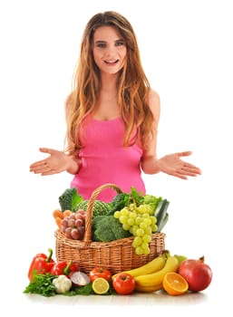 Young attractive woman with variety of fresh vegetables and fruits isolated on white