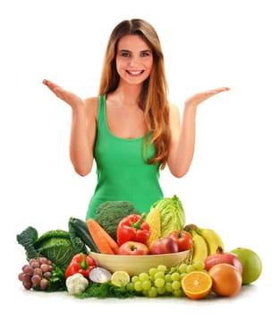 Young smiling woman with variety of fresh vegetables and fruits isolated on white