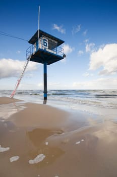deserted Baltic Sea beach with lifeguard tower in summer as a wide-angle shot