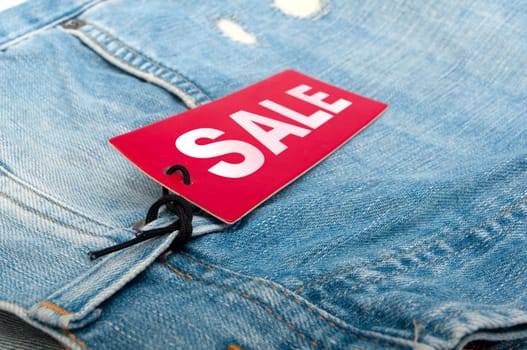 Closeup of Blue Jeans With Red Sale Tag - Shallow Depth of Field