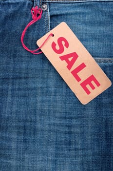 Closeup of Blue Jeans With Brown Sale Tag