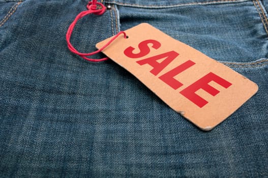 Closeup of Blue Jeans With Brown Sale Tag