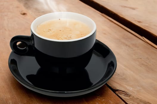 Cup of Smoking Espresso Coffee on Wooden Table