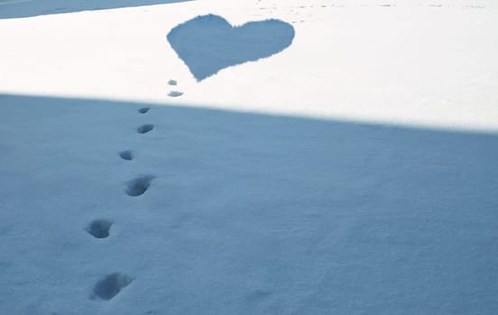Winter Love Background - Footsteps in snow covered meadow