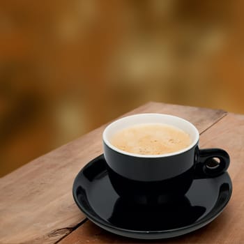 Cup of Smoking Espresso Coffee on Wooden Table on Blurry Background