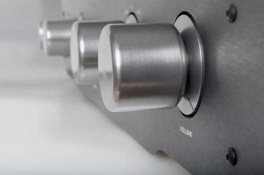 Volume Knob on Silver Metallic Amplifier - Shallow Depth of Field