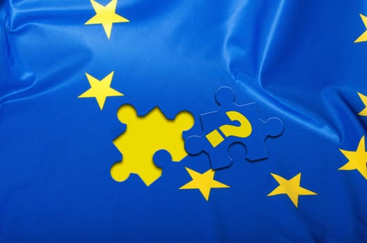 Euroscepticism - Detail of Silky Flag of Blue European Union EU Flag Drapery With Puzzle Piece With Question Mark