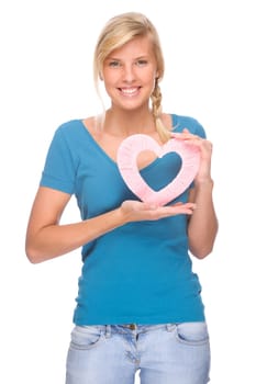 Studio shot of a young and happy woman with a heart