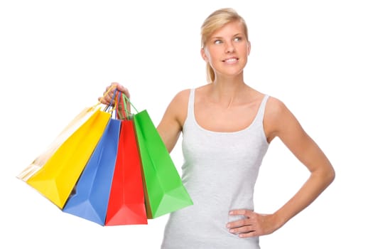 Studio shot of a young woman with shopping bags