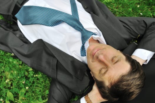 Senior people series - mature business man lying in grass and relaxing