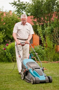 Senior man with lawn mower