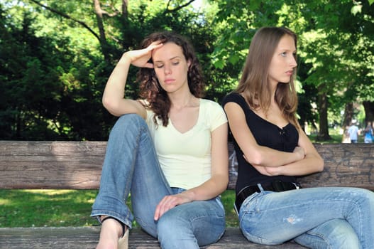 Friends outdoors series - two teenage girls are angry due to ther conflict