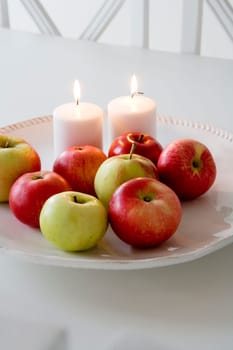 Red apples and candles on a table
